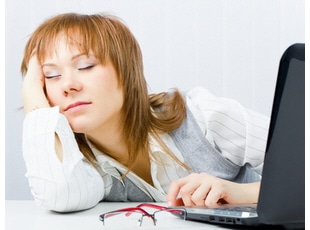 Worker, asleep on a laptop in the office