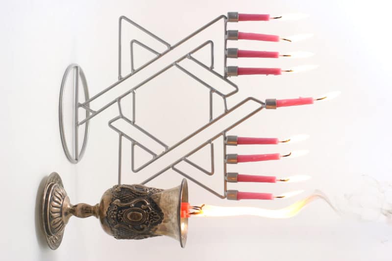 Menorah with candle and silver glass