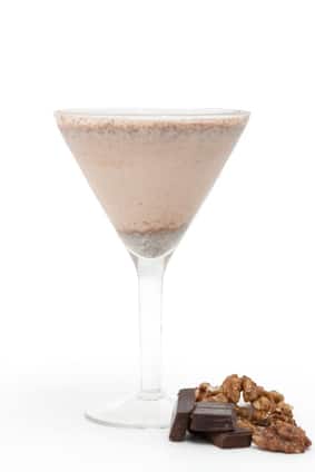 Chocolate nut-flavoured smoothie with chocolate and walnuts on background
